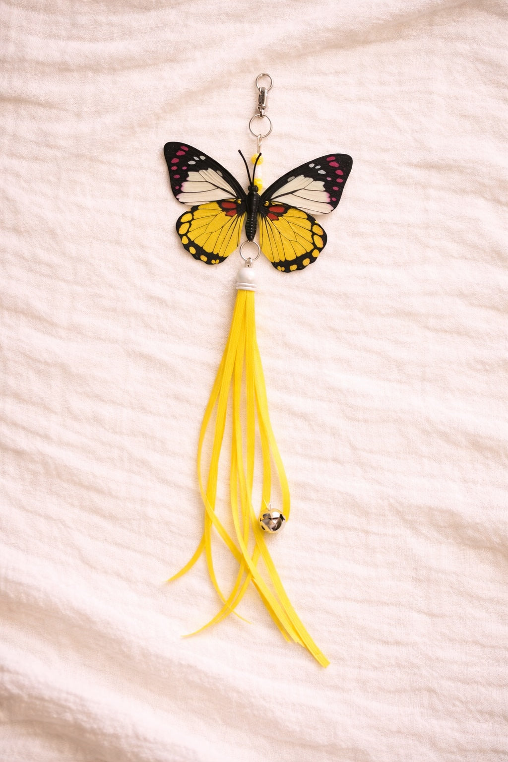 Yellow butterfly cat toy attachment with ribbon tail and clip connector